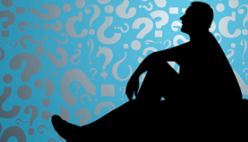 A silhouette of a man sitting in front of a sky of question marks